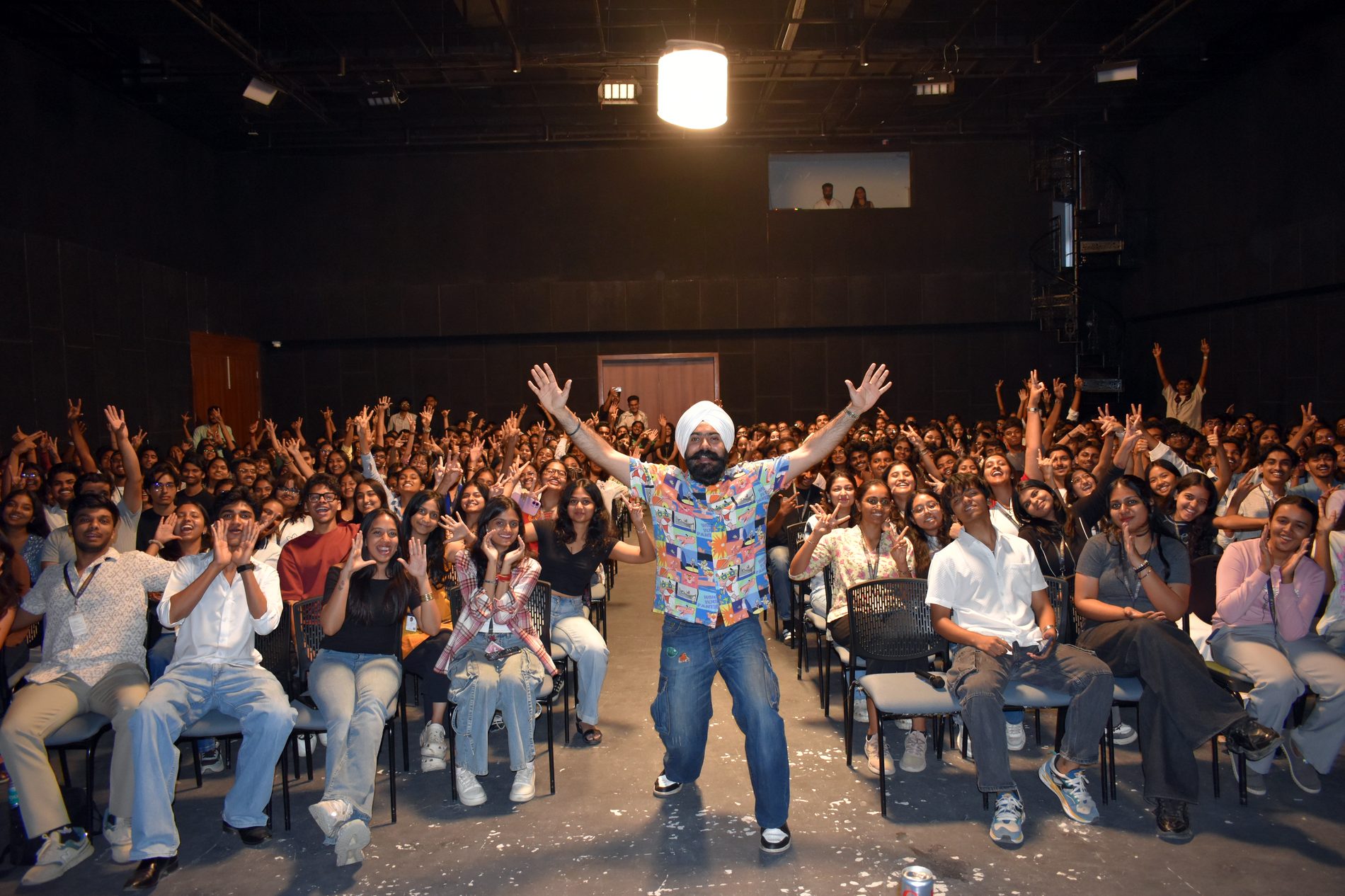 A crowd on its feet, hands up